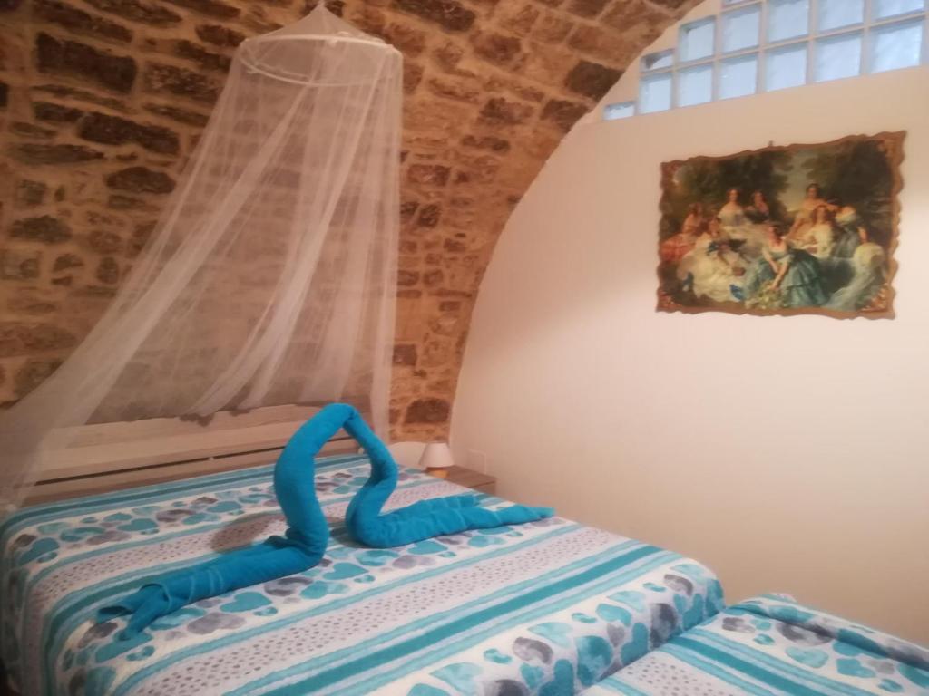 a table with a blue ribbon on it in front of a window at B&B S.Antonio in Bari