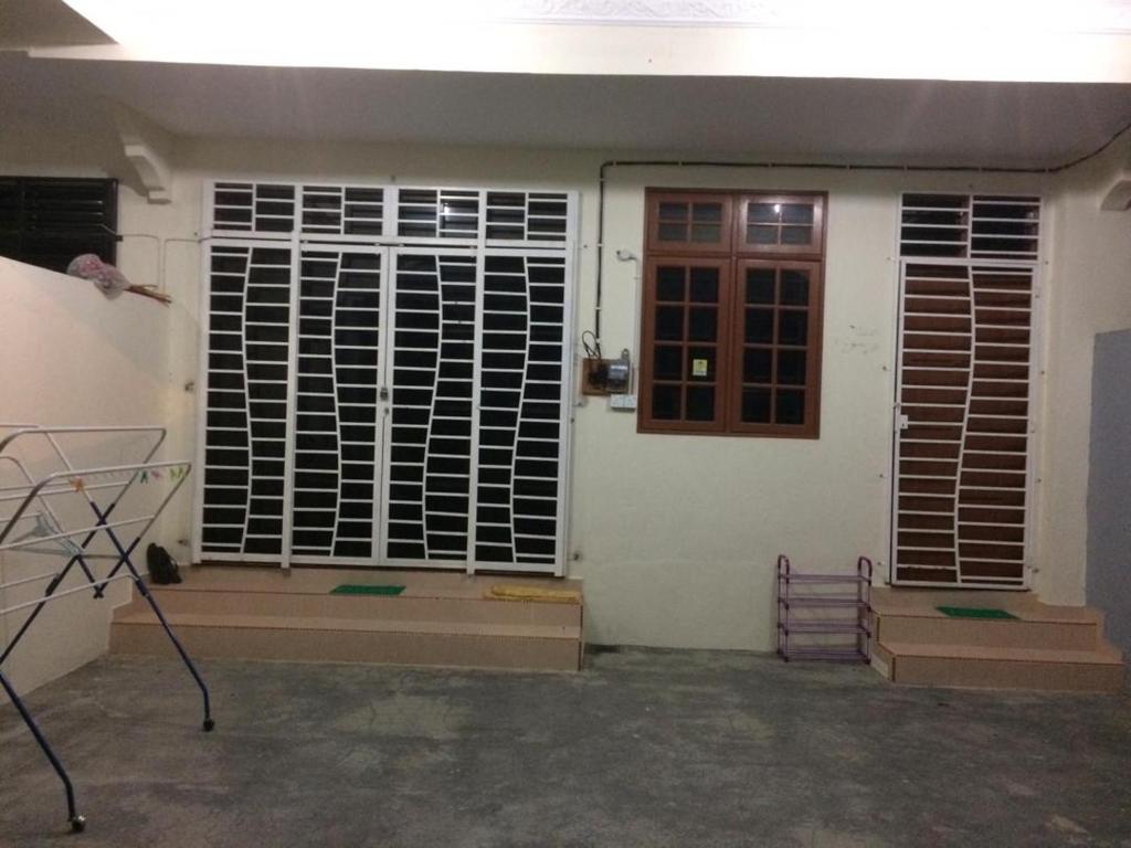 a front door of a house with a window at Sesuci Murni Homestay in Tanah Merah