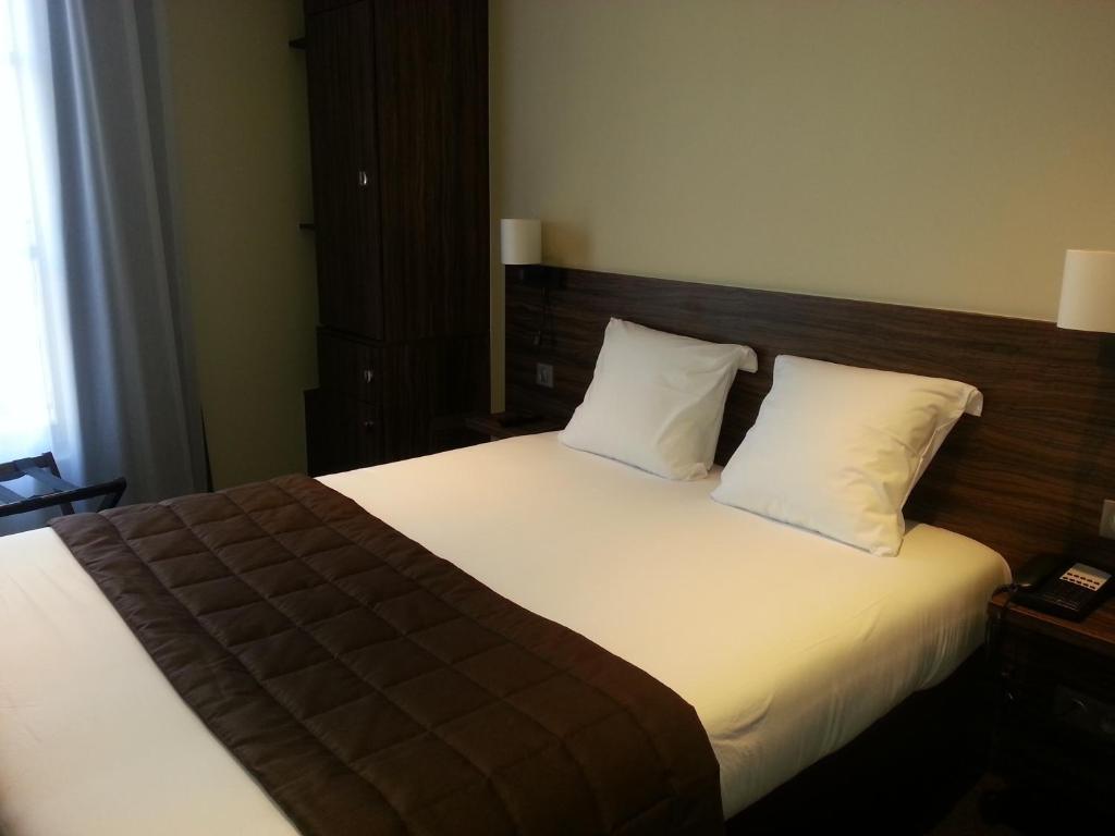 Postel nebo postele na pokoji v ubytování Hotel Vauban