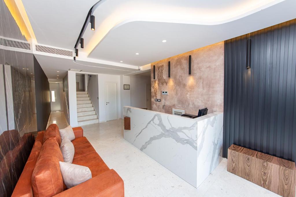 a living room with a couch and a counter at Inada Hotel Ksamil in Ksamil
