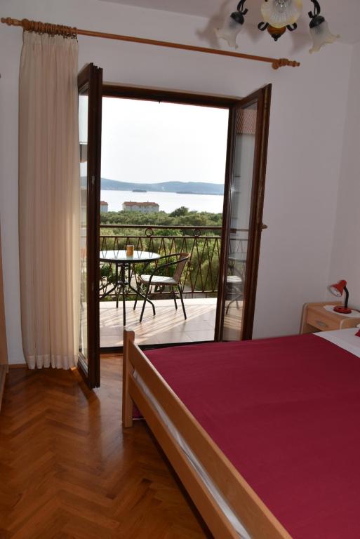 Postel nebo postele na pokoji v ubytování Apartmani Bošana