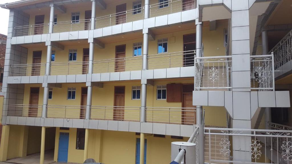 a building with balconies on the side of it at Hotel Dot Com Entebbe in Entebbe