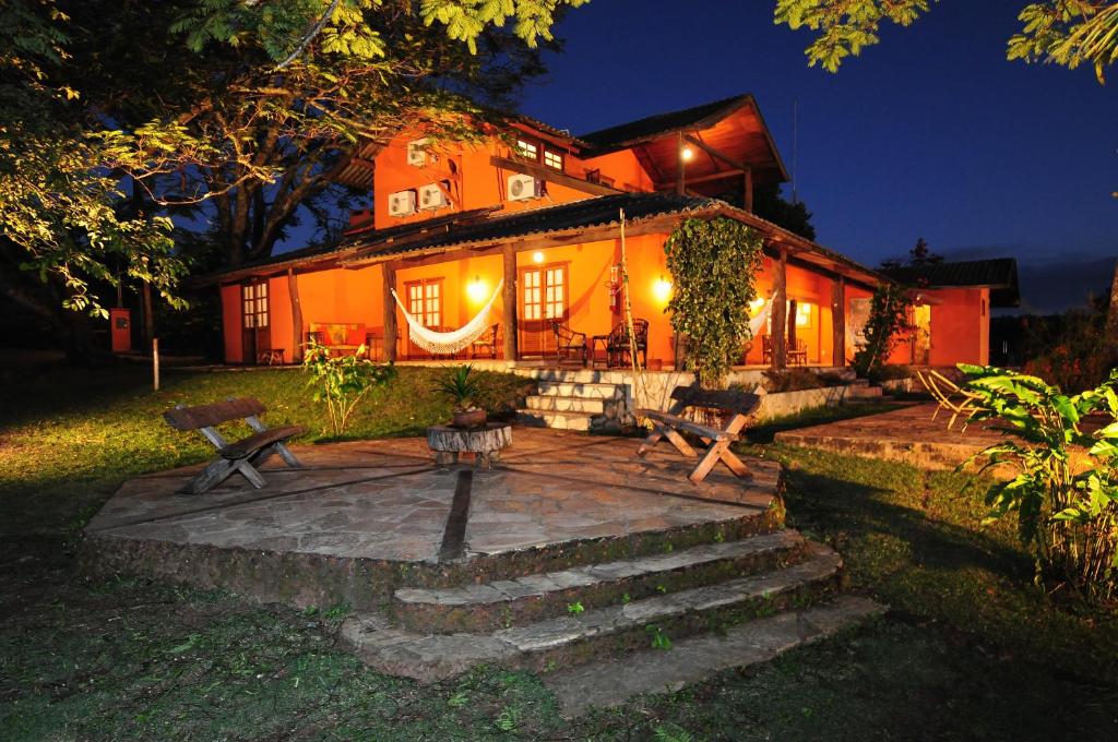 a house with a patio in front of it at night at Pousada do Parque in Chapada dos Guimarães