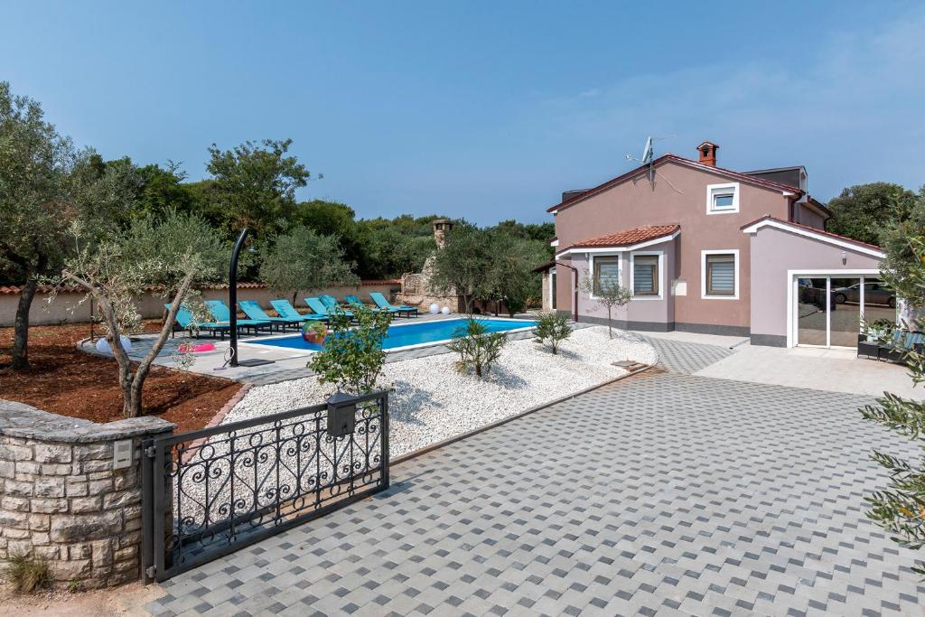 a villa with a swimming pool and a house at Villa Sunshine in Pula