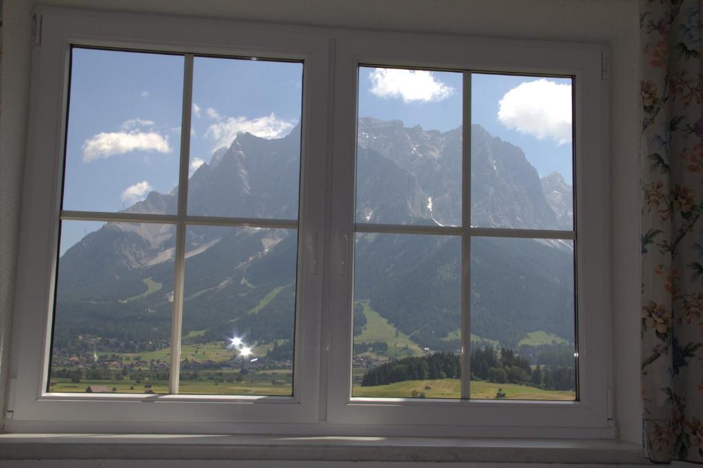 a window with a view of a mountain at Alpin-Sportiv in Lermoos