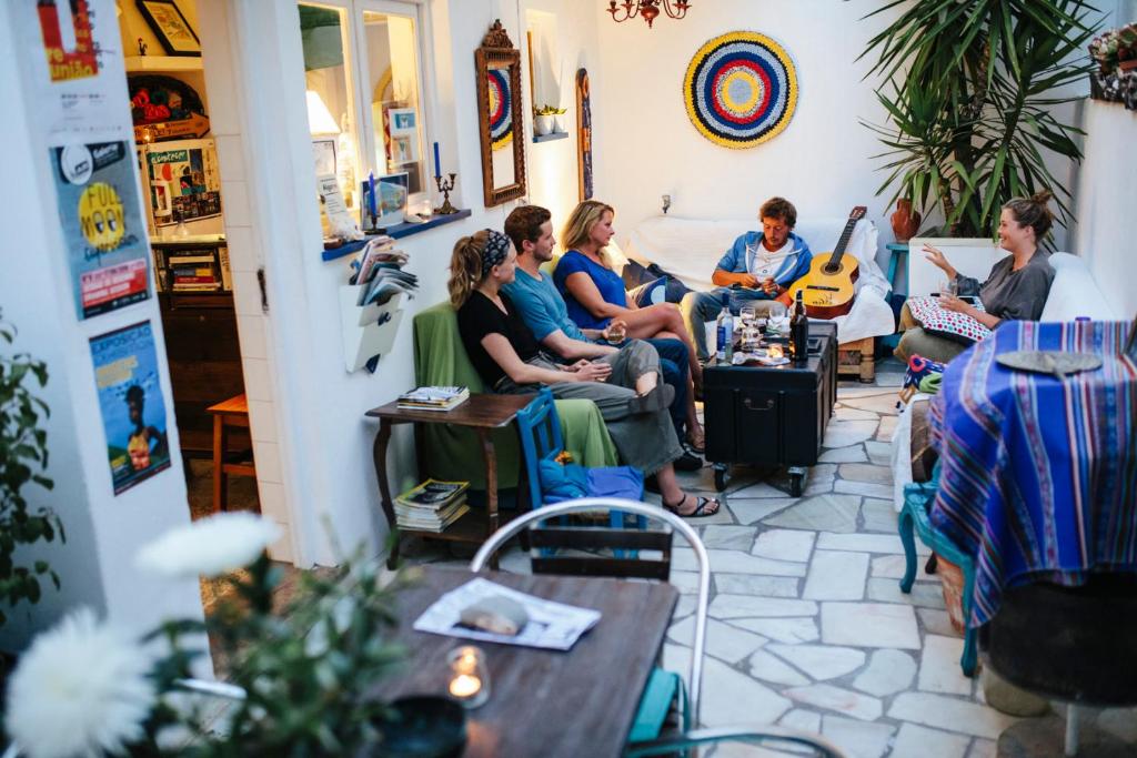
people sitting around a kitchen table at Olive Hostel Lagos in Lagos
