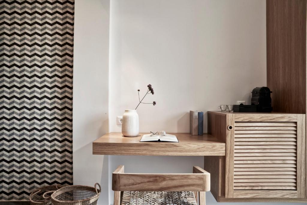 a wooden desk in a room with a curtain at Antigoni Seaside Resort in Ormos Panagias