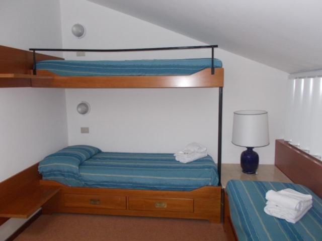 Un pat sau paturi într-o cameră la Sul mare di Punta Ala