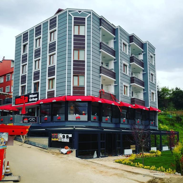 a large apartment building with a red and blue facade at İnce Apart Rezidence in Trabzon