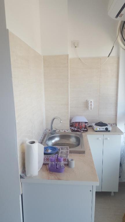 a kitchen with a sink and a counter top at Luxuries Beta in Saturn