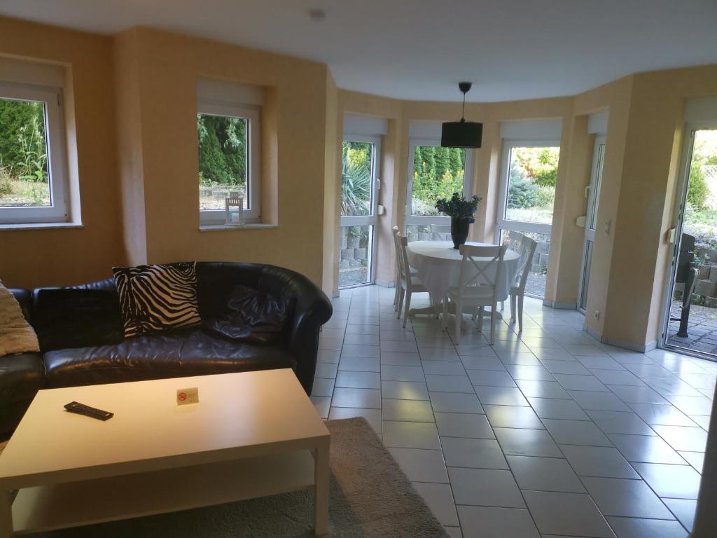 a living room with a couch and a table at Ferienwohnung Bella in Koblenz