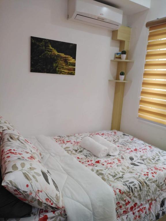 Postel nebo postele na pokoji v ubytování SMDC GRACE RESIDENCIES