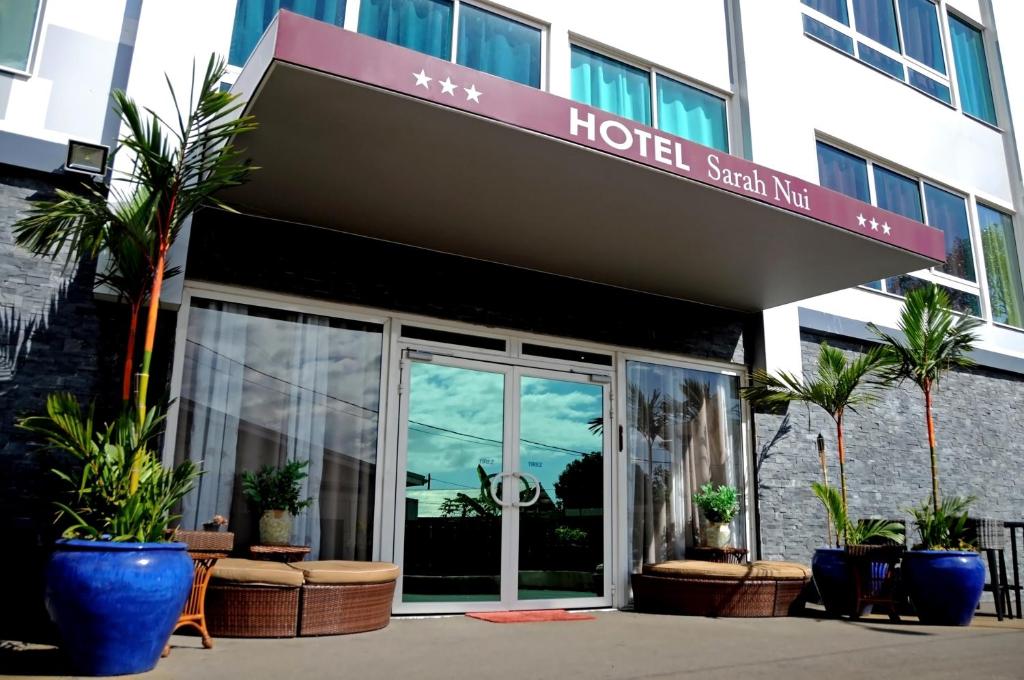 a hotel with a sign on the front of a building at Hotel Sarah Nui in Papeete