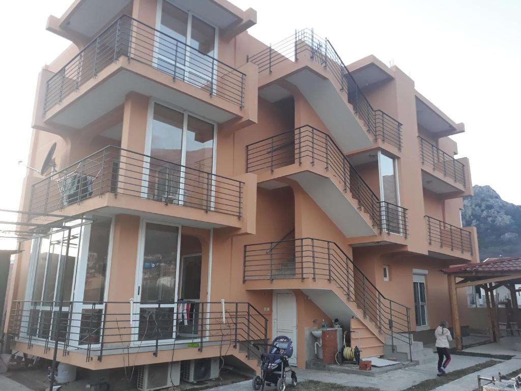 a building with balconies on the side of it at Apartmani Stojanović in Sutomore