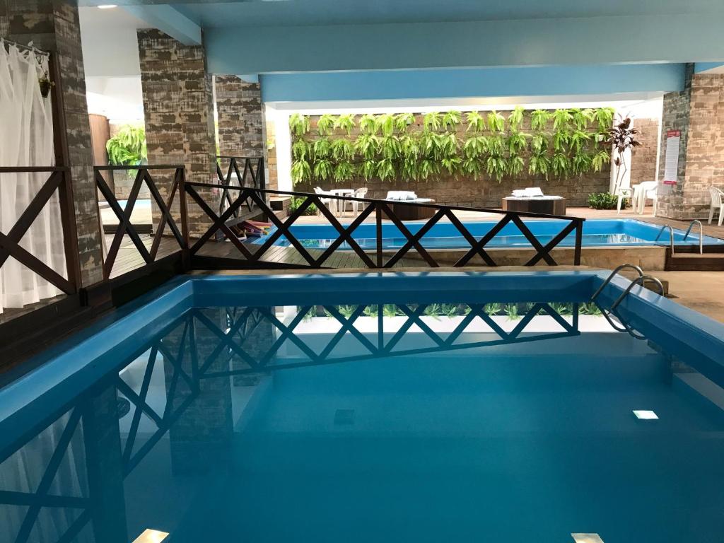 a view of a swimming pool with a bridge in a building at Hotel Rieger in Balneário Camboriú