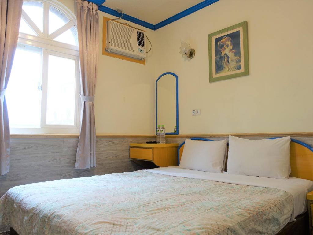 Postel nebo postele na pokoji v ubytování Fulong Haido Inn