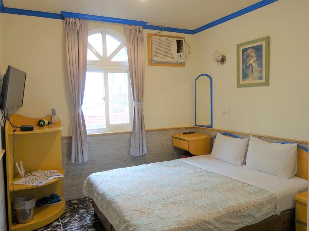 Postelja oz. postelje v sobi nastanitve Fulong Haido Inn