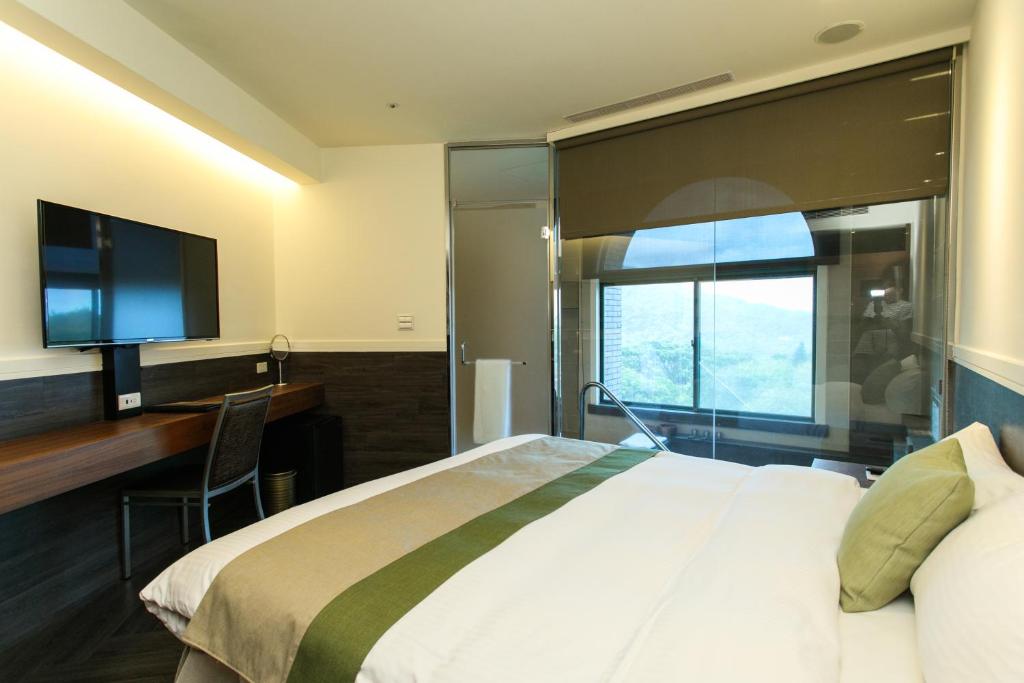 Postel nebo postele na pokoji v ubytování Yang Ming Shan Tien Lai Resort & Spa