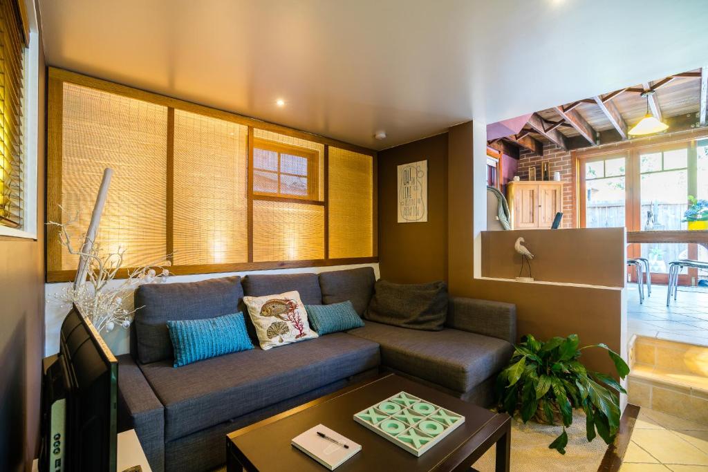 a living room with a couch and a table at 5 Stars Sydney City & Airport Retreat in Sydney