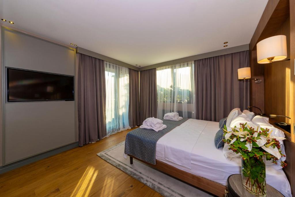 A bed or beds in a room at Opale Hotel