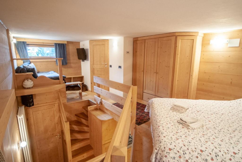 a bedroom with a bed and wooden cabinets at Mountain Loft in Tarvisio