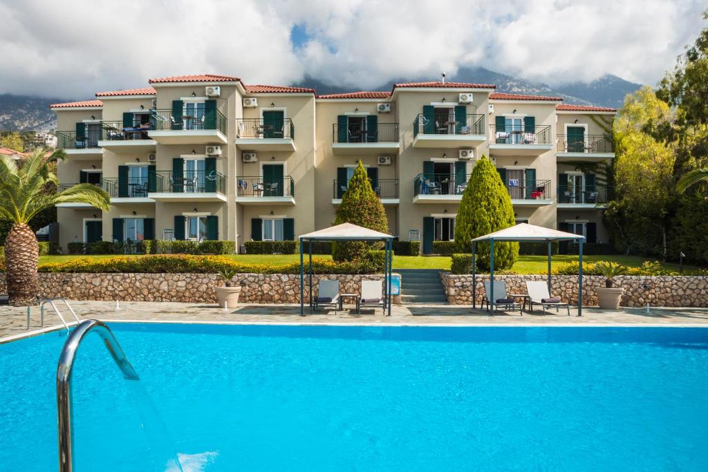 a hotel with a swimming pool in front of a building at Antonia Hotel in Vlachata