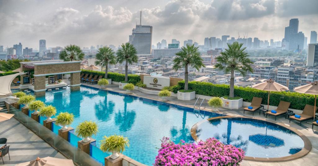 a swimming pool on the roof of a building with a city skyline at The Berkeley Hotel Pratunam in Bangkok