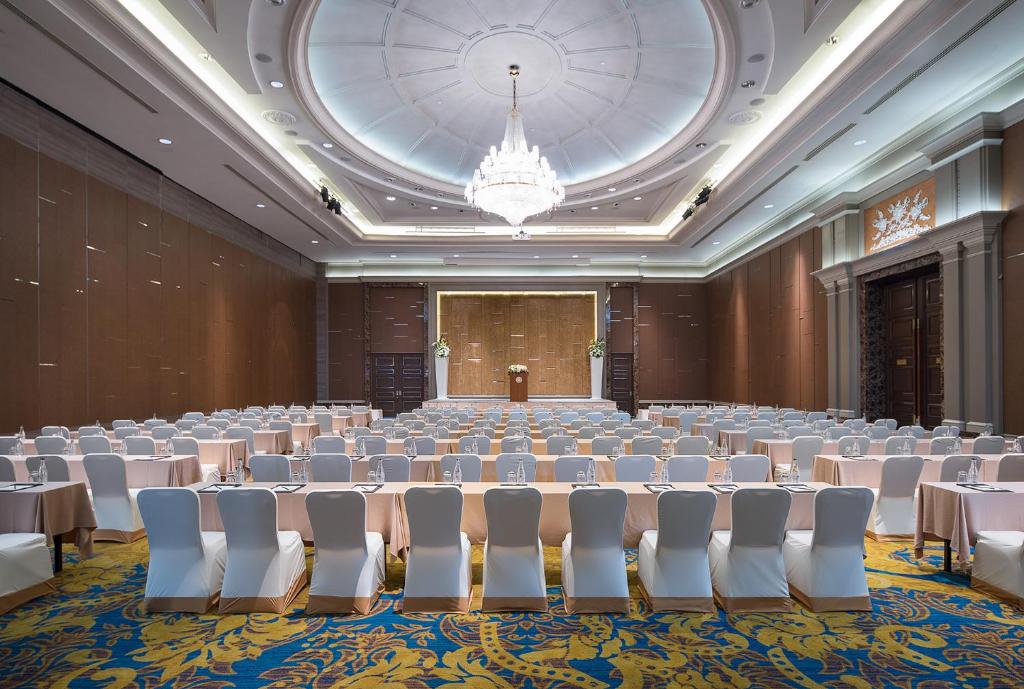 a large room with tables and chairs and a chandelier at The Berkeley Hotel Pratunam in Bangkok