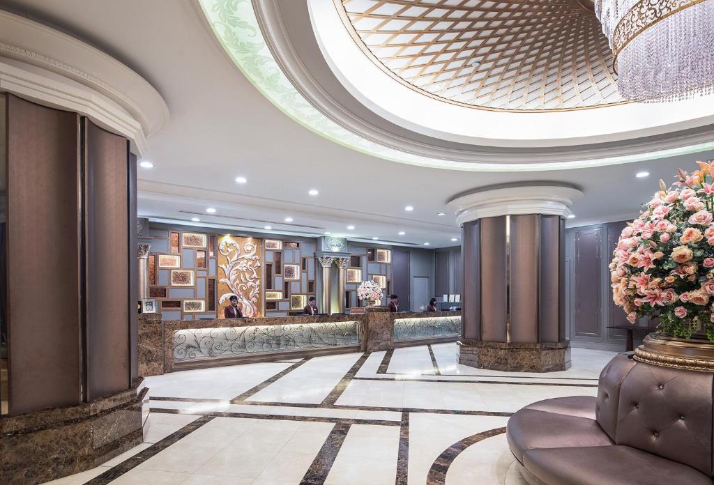 a lobby of a hotel with a large ceiling at The Berkeley Hotel Pratunam in Bangkok