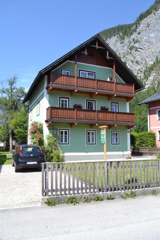 a house with a car parked in front of it at Gingin- rooms in Hallstatt