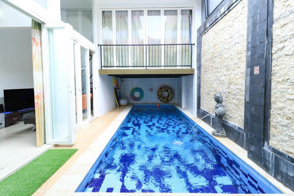 a swimming pool in the middle of a house at Donata House in Jimbaran