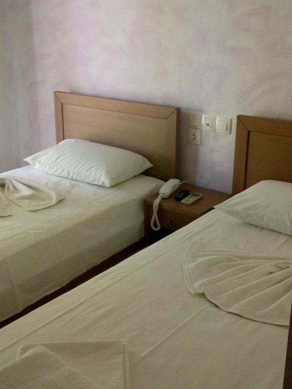 Postel nebo postele na pokoji v ubytování Hotel Ion