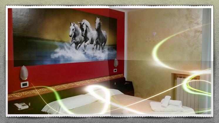 a room with a painting of horses on the wall at Hotel Rosa Serenella in Bardonecchia