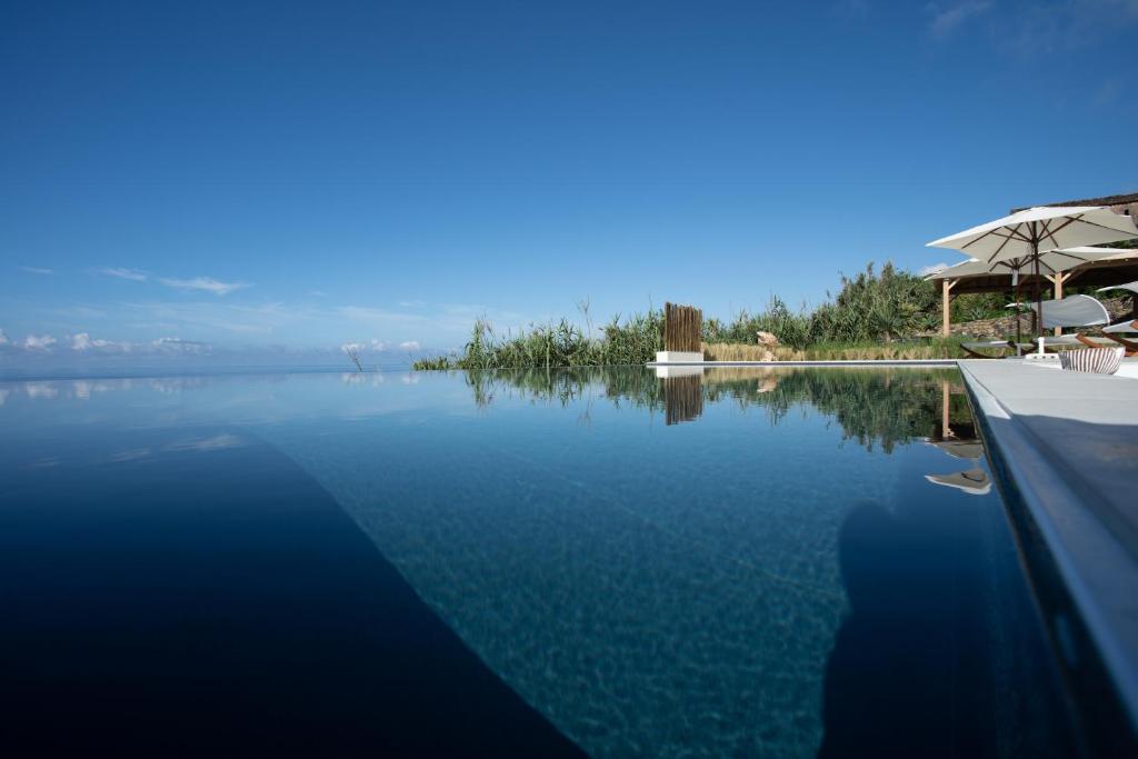 a swimming pool with a view of the water at Sul Villas & Spa - Azores in Lagoa