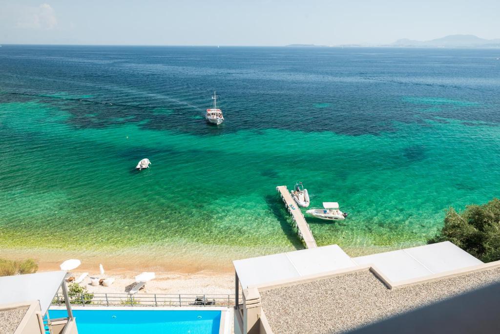 an aerial view of a beach with boats in the water at Glyfa Beach Villas in Barbati