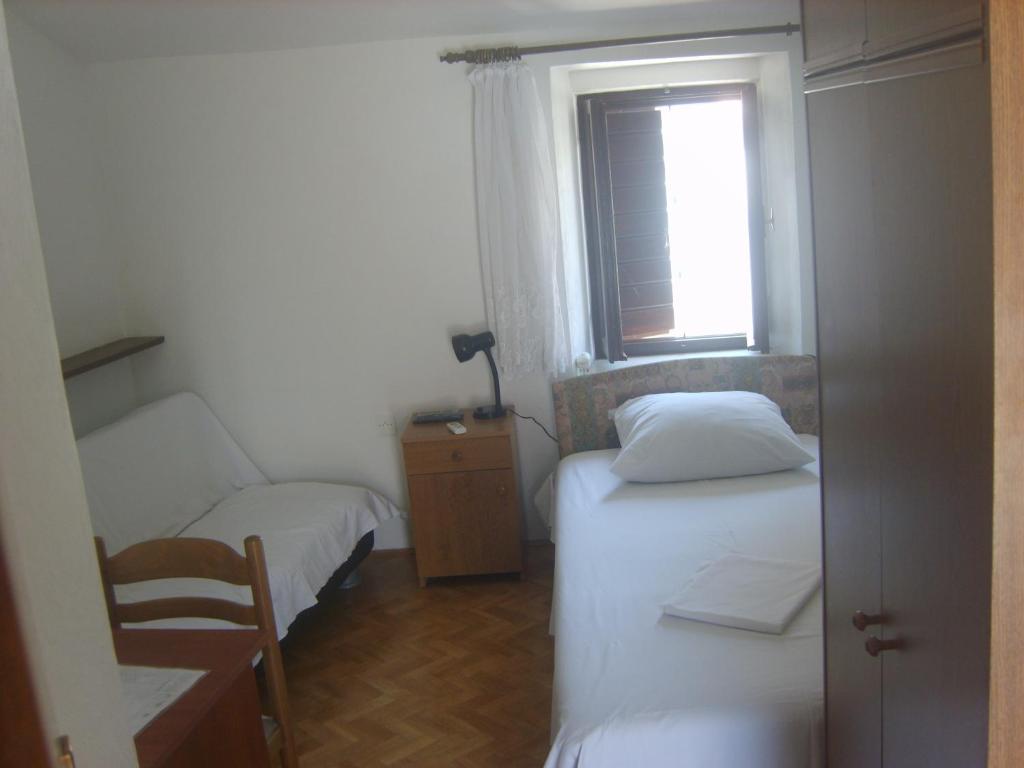 Postel nebo postele na pokoji v ubytování Rooms Roso