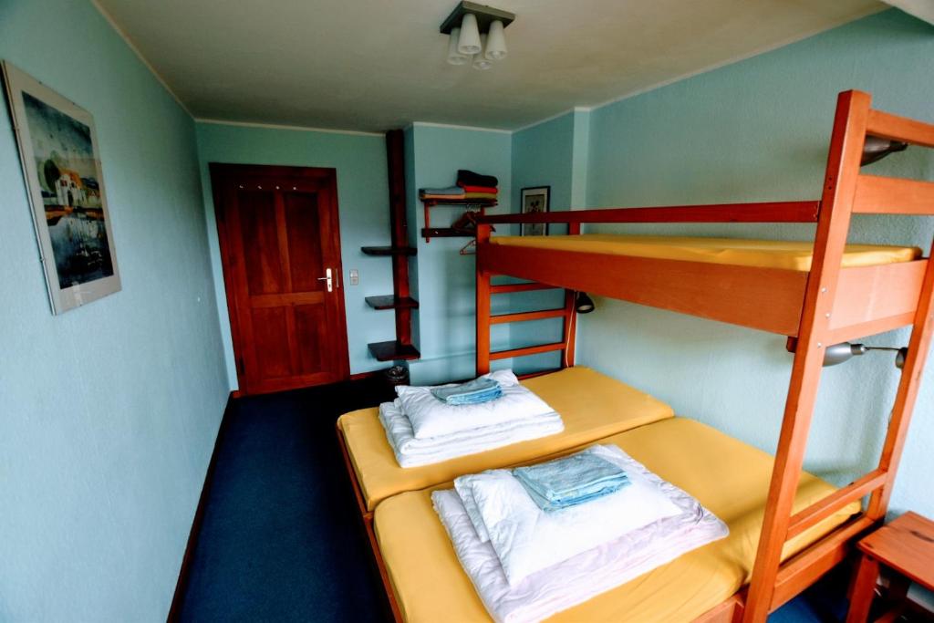Postel nebo postele na pokoji v ubytování Herberge Orange