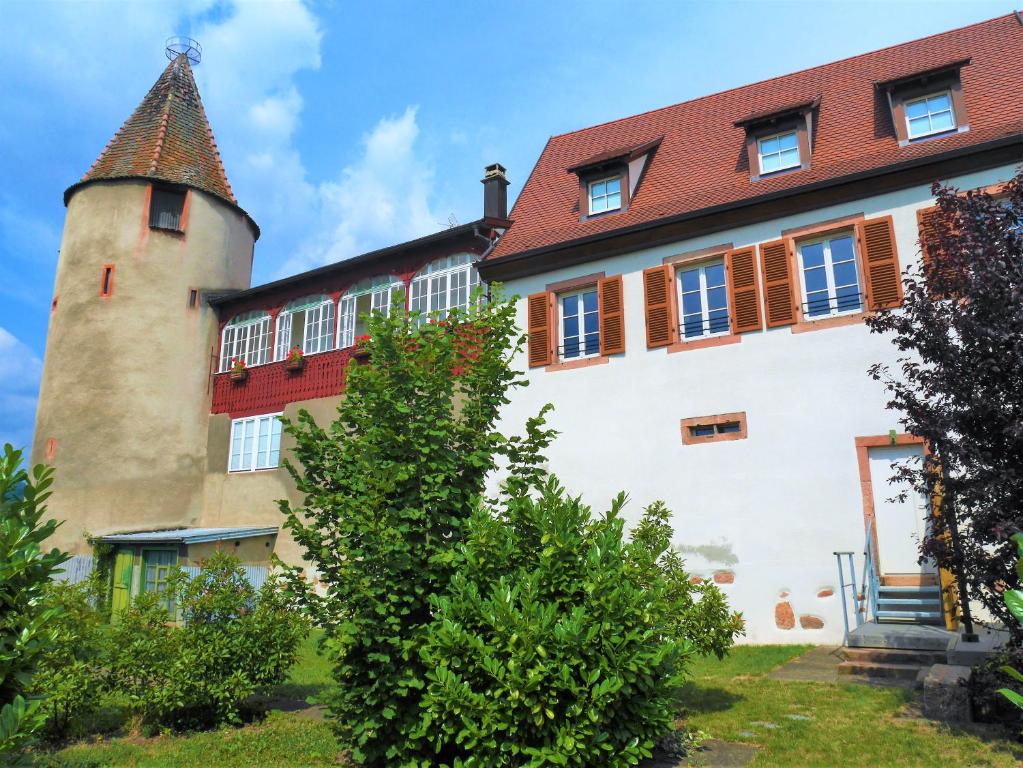an old building with a tower on top of it at Les gîtes de la Tour, appartement "La Plaine" in Saint-Hippolyte