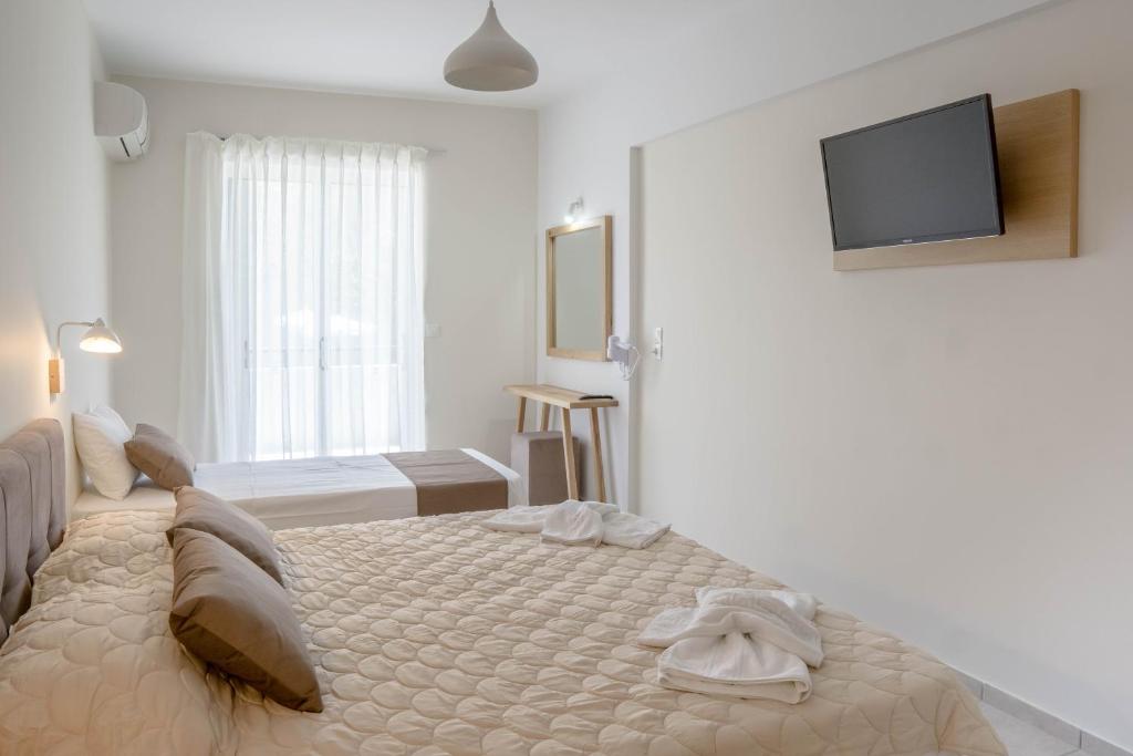Postel nebo postele na pokoji v ubytování Pinelopi Hotel