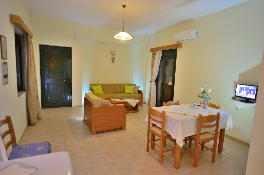 a living room with a table and a couch at Xenios Zeus Apartments in Kissamos