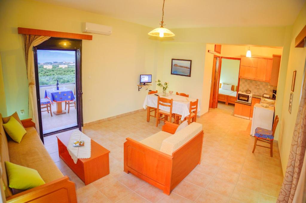 a living room with a couch and a table at Xenios Zeus Apartments in Kissamos