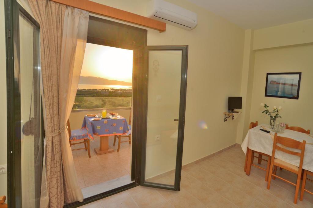 a room with a table and a dining room at Xenios Zeus Apartments in Kissamos