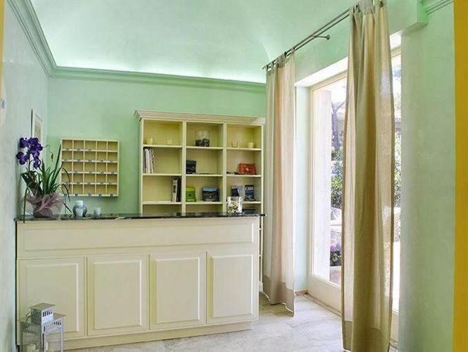 a living room with a counter and a window at Guerrini Hotel in Castiglioncello