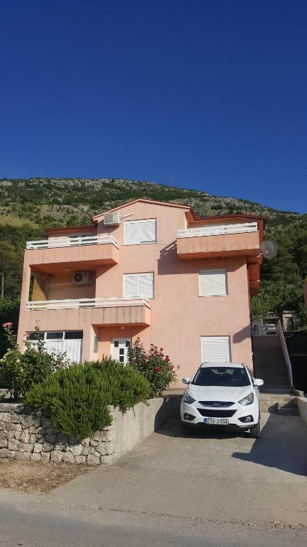 a car parked in front of a house at Apartmani Milan in Trebinje