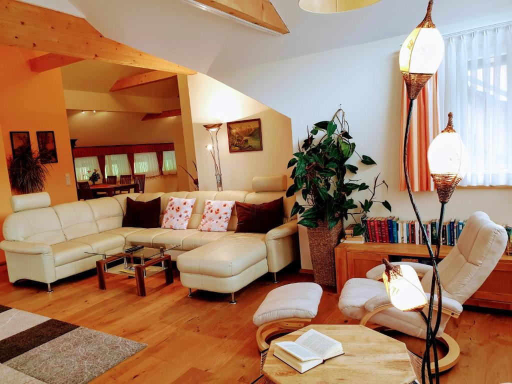 a living room with a couch and a table at Haus Bergblick in Altaussee