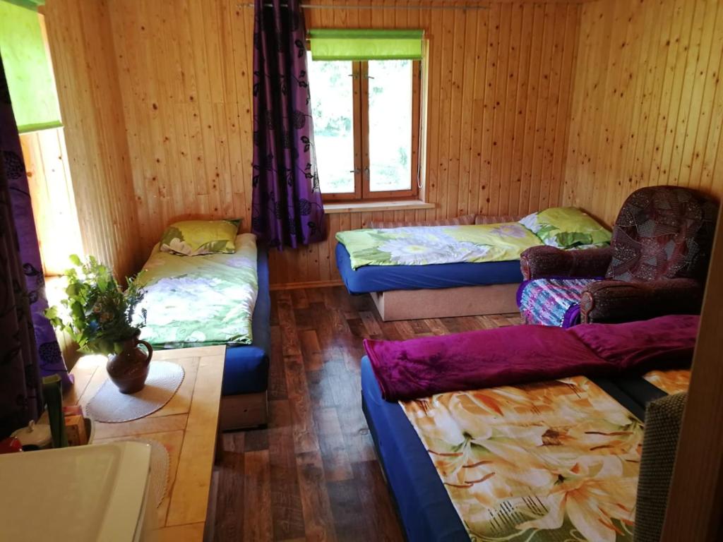 a living room with three beds and a couch at Rožu 20 in Mērsrags