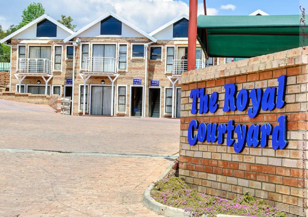 a brick building with a sign that reads the royal courthouse at The Royal Courtyard in Matatiele