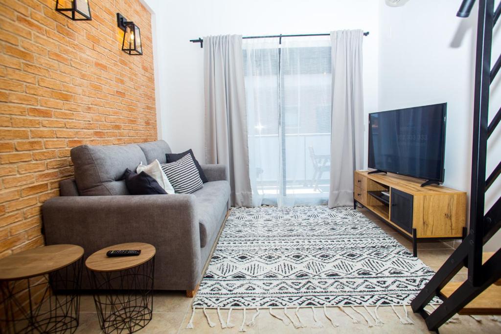 Televízia a/alebo spoločenská miestnosť v ubytovaní AL27 Duplex de diseño a 250 metros de la playa