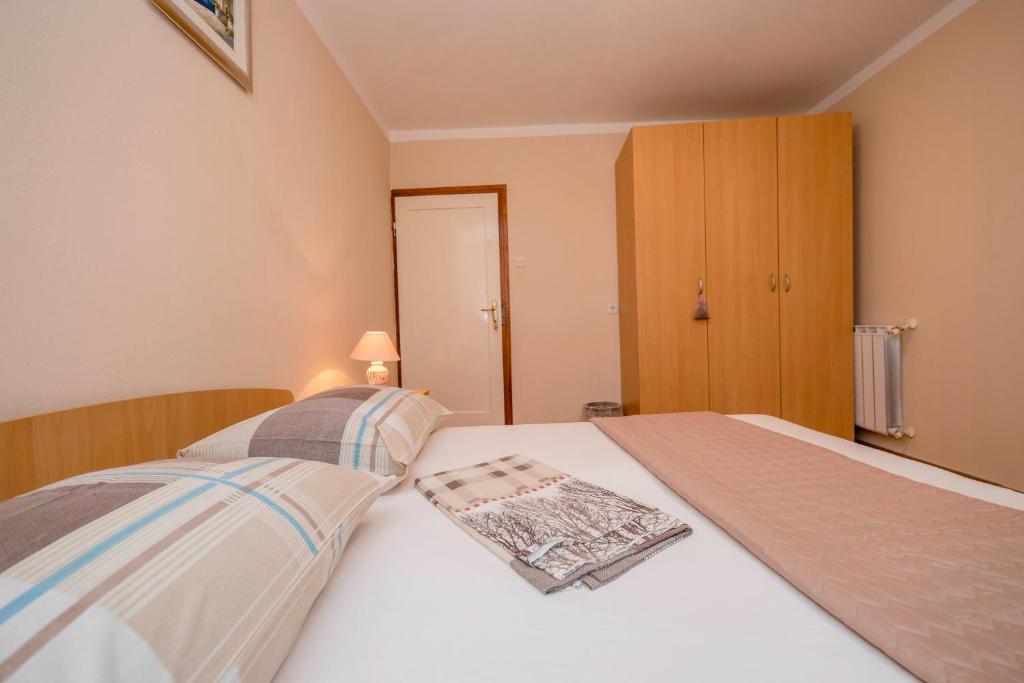 Posteľ alebo postele v izbe v ubytovaní Apartmani Rab
