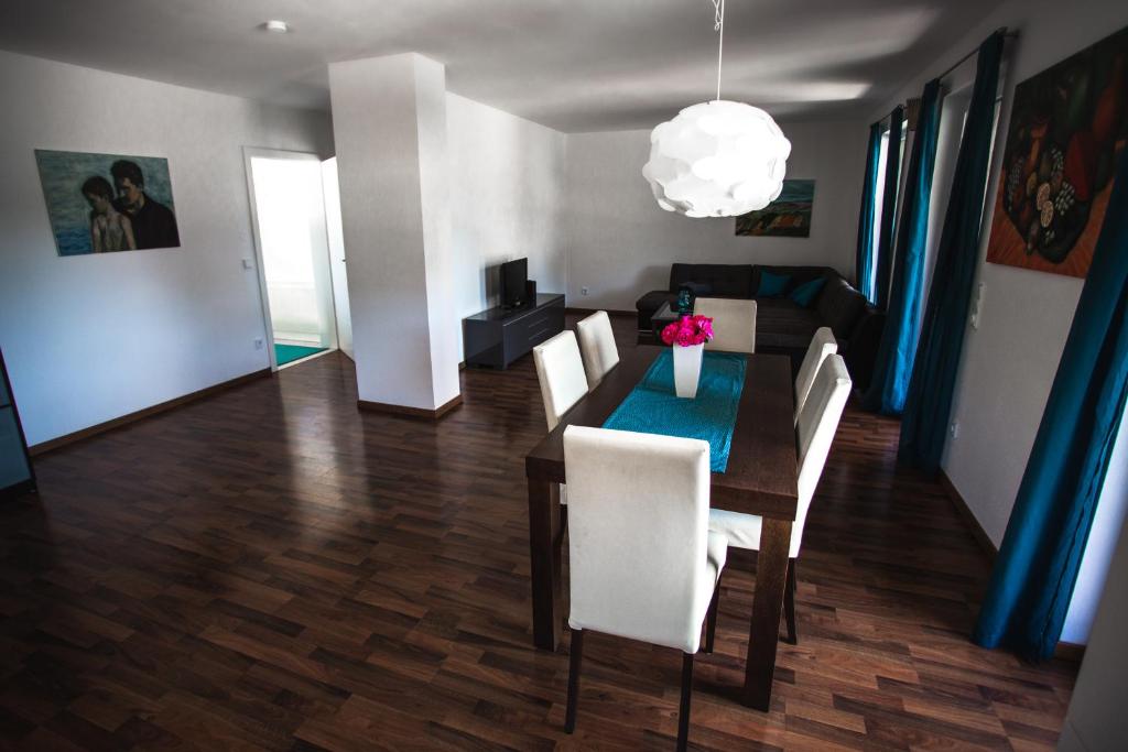 a dining room with a table and white chairs at Peter's in Koppl